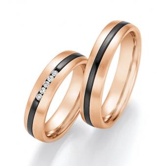 Aufnahme von Eheringen aus Rosegold mit Diamanten und geschwungenem Streifen aus Zirconium 